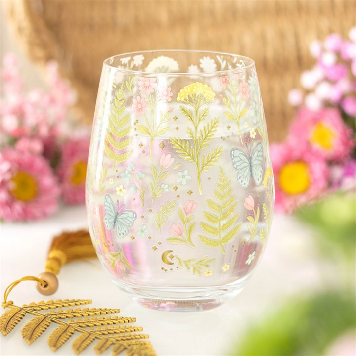 Decorative glass with floral and butterfly design on a blurred floral background