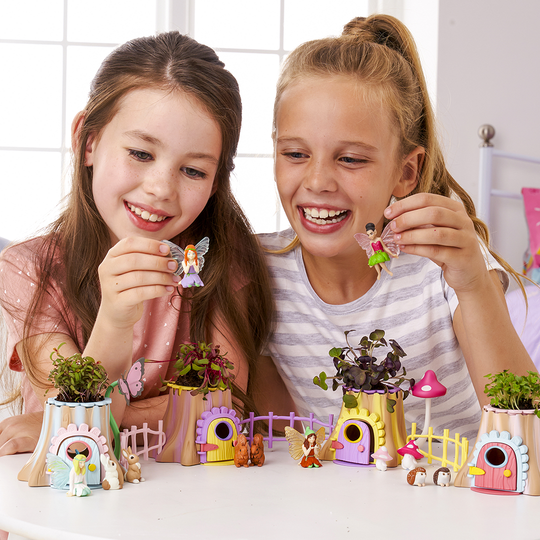 Girls playing with all 4 fairy tree houses