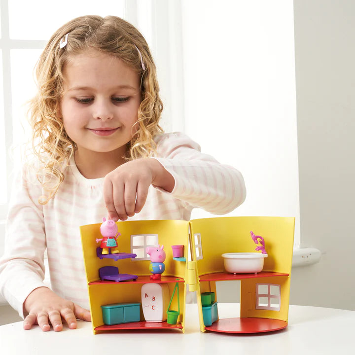 Girl playing with Peppa's playhouse pot