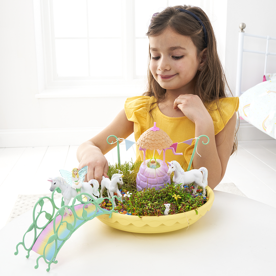 Girl playing with the Unicorn Garden and Magical wishing well toy
